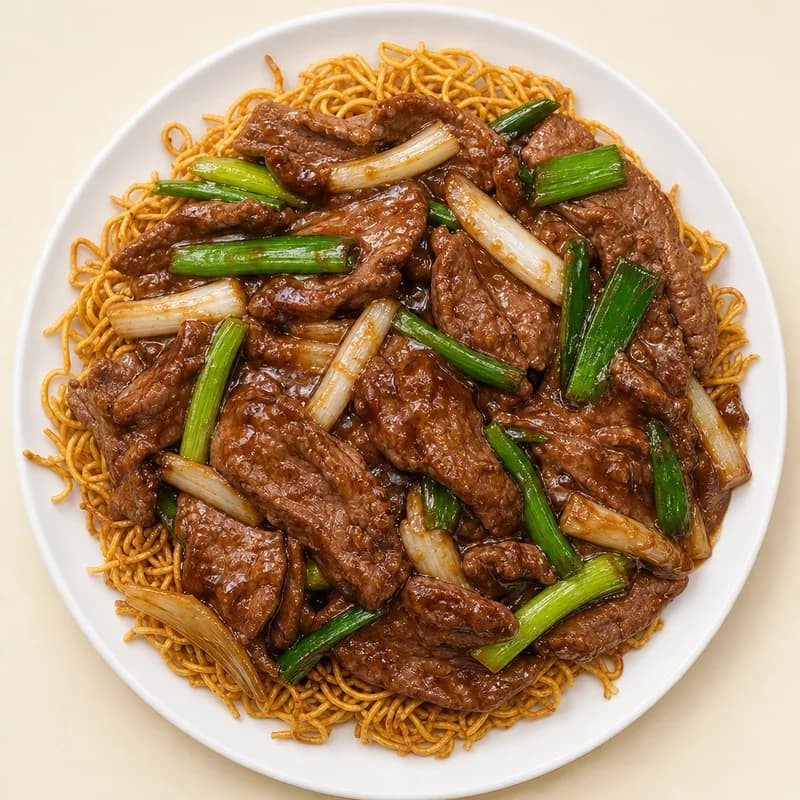 Sliced Mongolian beef with green and white onions in brown sauce